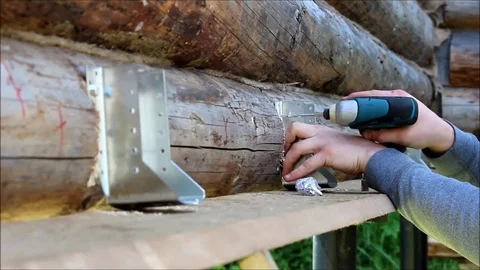 The worker screw the screws into the pre-drilled holes with a screwdriver. Stock Footage 82084272