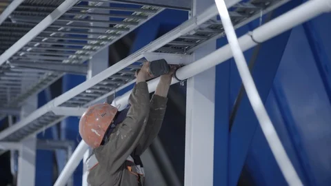 Worker with screwdriver and bit screwing screw at factory. Industrial instrument Stock Footage 126542294