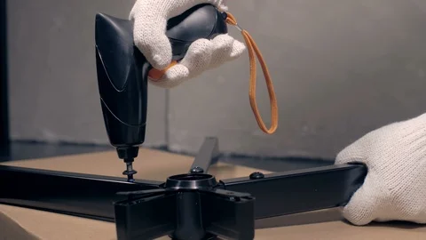 Worker with screwdriver assembling the chair Stock Footage 91847676