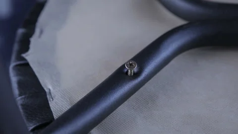 Worker with screwdriver assembling the chair Stock Footage 118761735