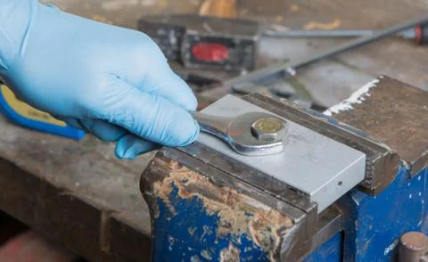 Worker is screwed a nut with a wrench Stock Photos