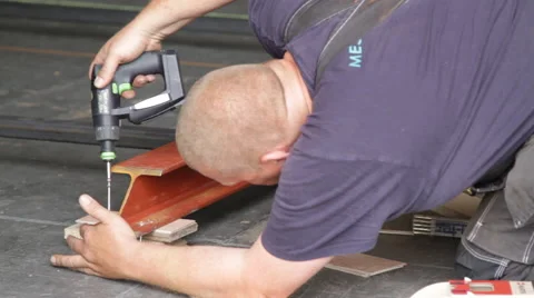 Worker screwing a piece of metal Stock Footage 60640549