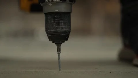 A worker screws a chipboard with an electric screwdriver. Stock Footage 247702786