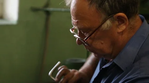 The worker screws the nut onto the parts. Stock Footage 86490559