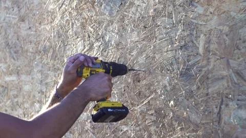 A worker screws a screw into a wall 4K Stock Footage 294047272