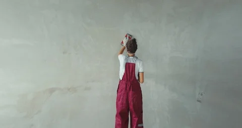 Worker scrubbing wall with sandpaper Stock Footage 113120202