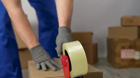 Worker sealing box with tape for moving, close-up Stock-Footage 264502062