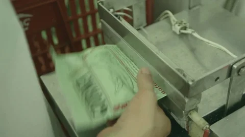 Worker sealing chip packets Stock Footage 77099936