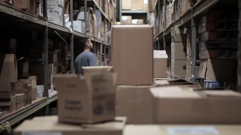 Worker searching for item in a warehouse Stock Footage 72661241