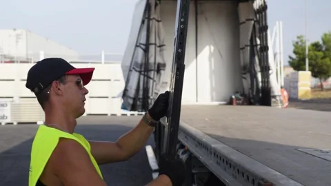 Worker Securing Truck Door Locks at Industrial Site Stock Footage 337799549
