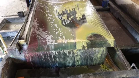 Worker separating copper from water in Scrap in factory Stock Footage 318644138