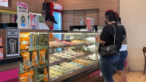 Worker Serving Customers at Dunkin' Donuts Store Stock Footage 228574748
