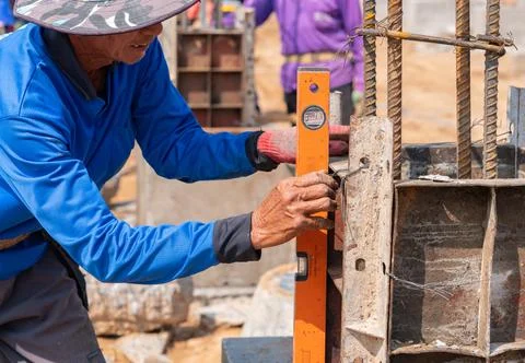 Worker set be perpendicular frame of pole Stock Photos