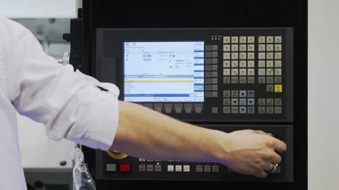 A worker sets up equipment at a factory. Stock Footage 273718564