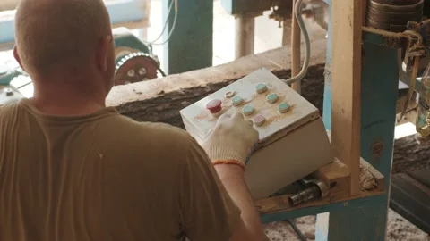 Worker sets the program with the control panel on an automatic woodworking  Stock Footage 133780383