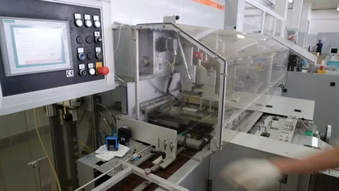 Worker sets the program on the display. Production line for the production of Video stock 74202437