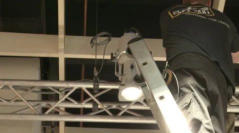 Worker setting up spotlights on the roof Stock Footage 60699855