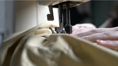 A Worker Sewing Clothes With A Weaving Machine Footage 4K Stock Footage 253842889