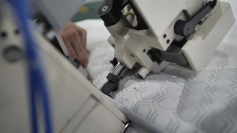 Worker sewing edges of mattress. 動画素材 240757492