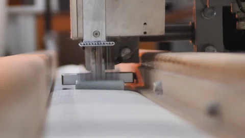 Worker sewing edges of mattress with help equipment in factory indoors. Stock-Footage 240757163