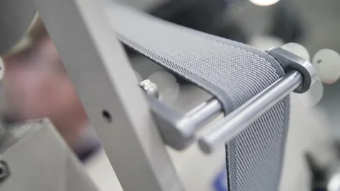 Worker sewing edges of mattress with help equipment in factory indoors. Stock-Footage 240757271