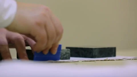 A worker in a sewing workshop. Layout pattern on fabric. Closeup view Stock Footage 95396396