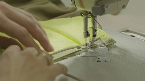 Worker sewing a zipper into a textile Stock Footage 69855809