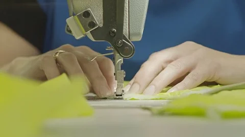 Worker sewing a zipper into a textile Stock Footage 69855992