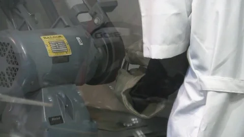 Worker shapes and smooths golf club with industrial belt sander machine Video stock 125332068