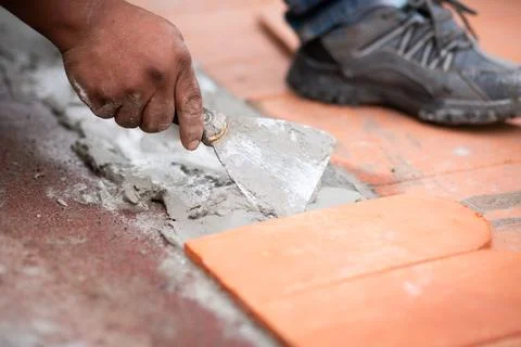 Worker Shaping Fresh Cement with Trowel for Tile Placement Stock Photos