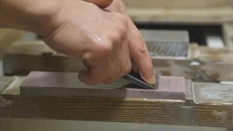 Worker sharpening his tool on the slab Stock Footage 87837380