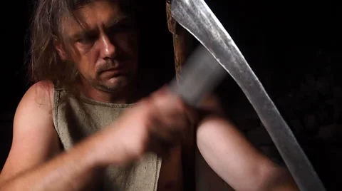 Worker sharpening a scythe Stock-Footage 28993462