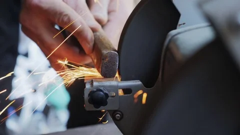 Worker sharpening tools by grinding wheel Stock Footage 79028951