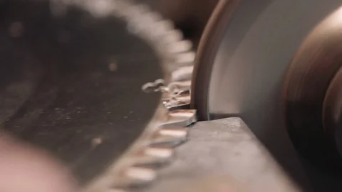 Worker sharpens a circular saw blade - close up shot Stock Footage 75708824