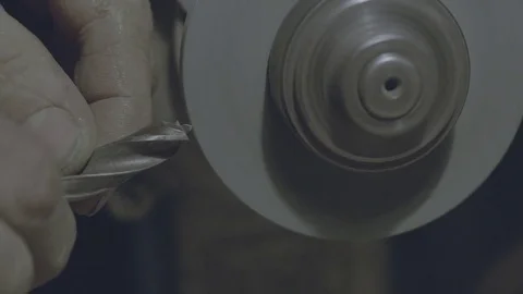The worker sharpens the tool. Work on a sharpening machine. Stock Footage 81698189