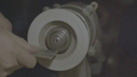 The worker sharpens the tool. Work on a sharpening machine. Stock Footage 81698296