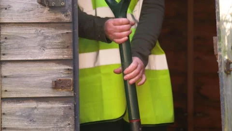 Worker in shed with garden fork Stock Footage 163737490
