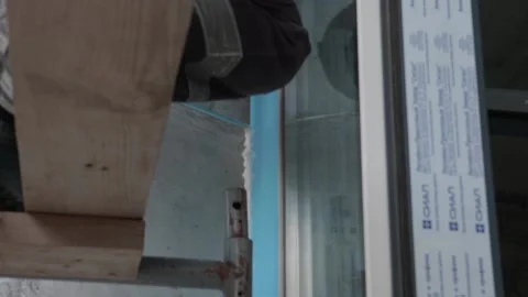 Worker shoots seams on door structure 10.06.2020 Stock Footage 132494183