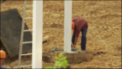 Worker with a shovel at a construction site digs sand and mortar, background Stock-Footage 307206999