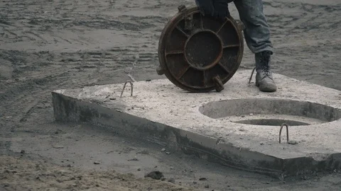 Worker with a shovel at a work construction. Construction machinery works at a c Stock Footage 121872208