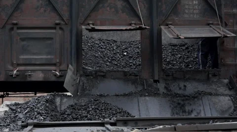 Worker is shoveling coal from a train Stock Footage