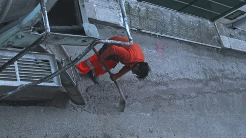 Worker Shoveling Fresh Cement pre-mixed concrete in the track, which drips fr Video stock 211370581