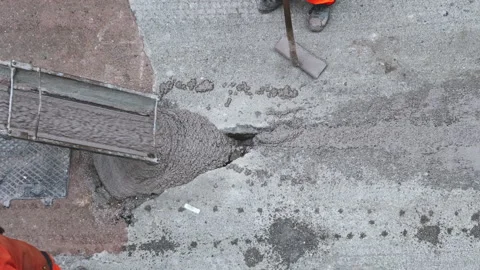 Worker Shoveling Fresh Cement pre-mixed concrete in the track, which drips fr Video stock 211372228
