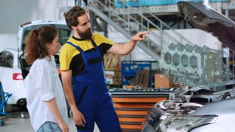 Worker shows client car engine hologram Stock Photos