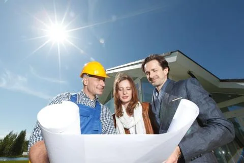 Worker shows house design plans Stock Photos