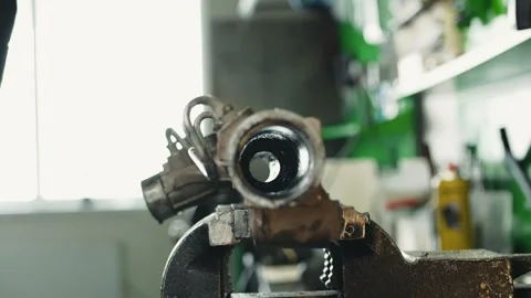 Worker shows inner part of steering rack with tie rod extends internal piston Stock Footage 284544817