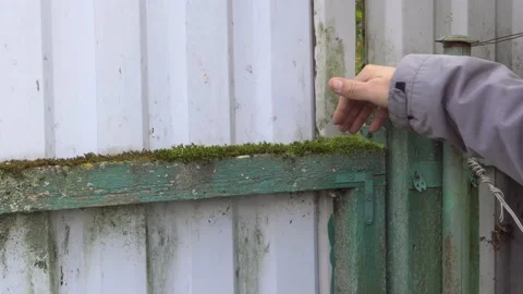 A worker shows the required amount of work to repair the gate. Stock Footage 161606228