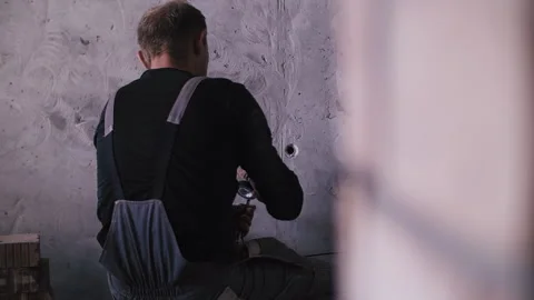 A worker sips electrical wiring in a wall Stock Footage 252195916