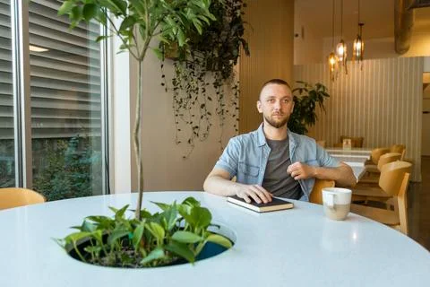 Worker sits at table during online education session in modern workspace se.. Фото