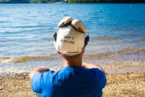 Worker sitting on the beach . Stock Photos